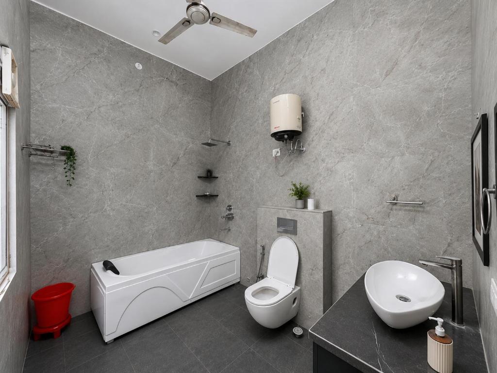 a bathroom with a white toilet and a sink at Hotel Oxygen Stay in Noida