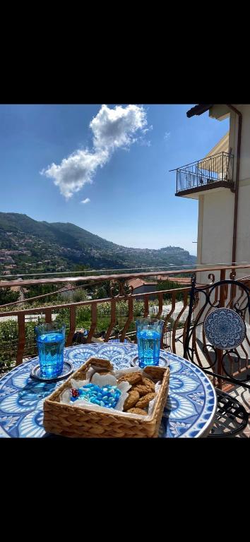 a table with a basket of bread and glasses on a balcony at Casa Vacanze Alba in Pianillo