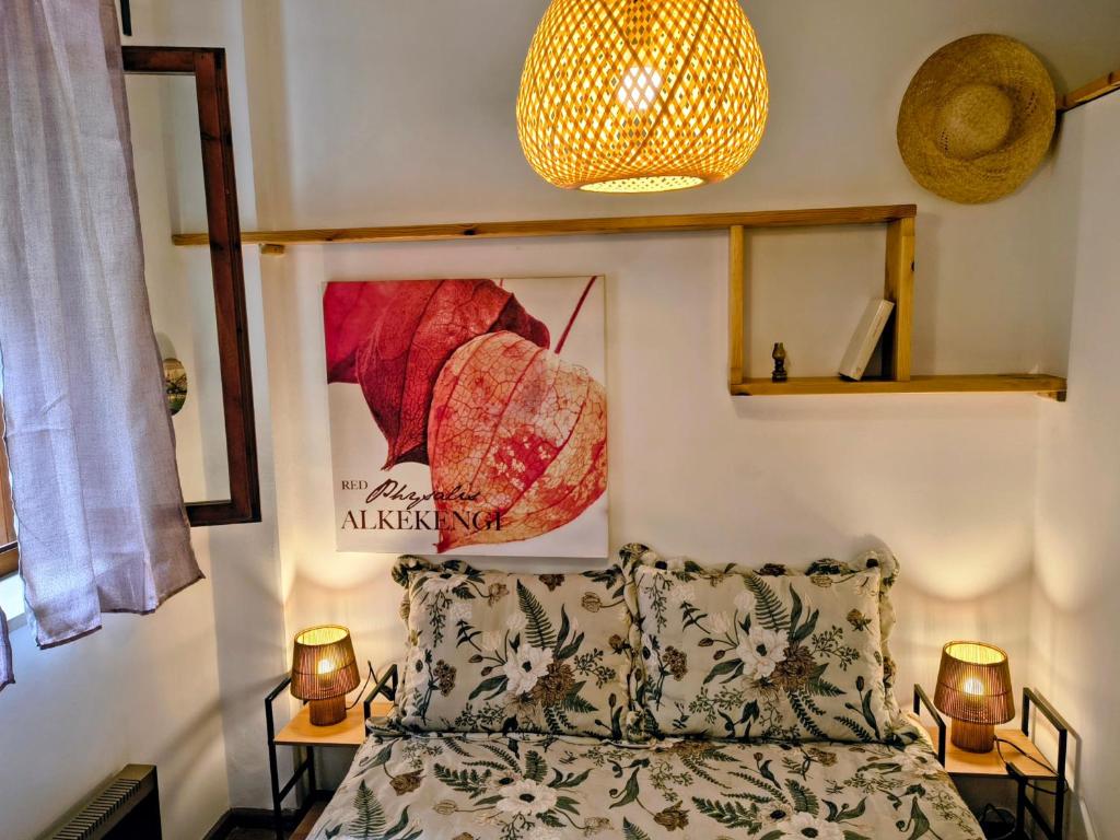 a bedroom with a bed and two tables with lamps at Tiny home in Camigliatello Silano