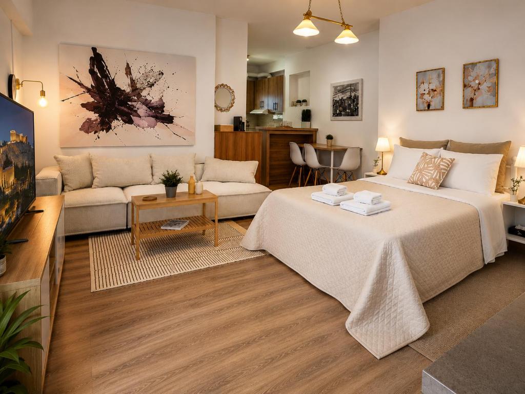 a living room with two beds and a couch at Cloud9 Airport Suites in Koropi