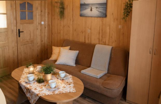 a living room with a couch and a table at Domki Boja in Swarzewo