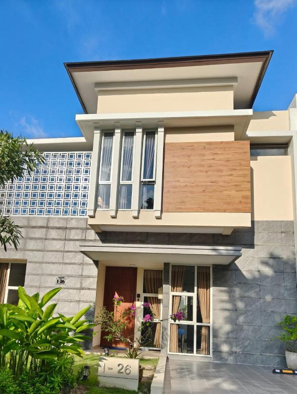 a house in front of a building at Prosperity House Southlinks in Bagam