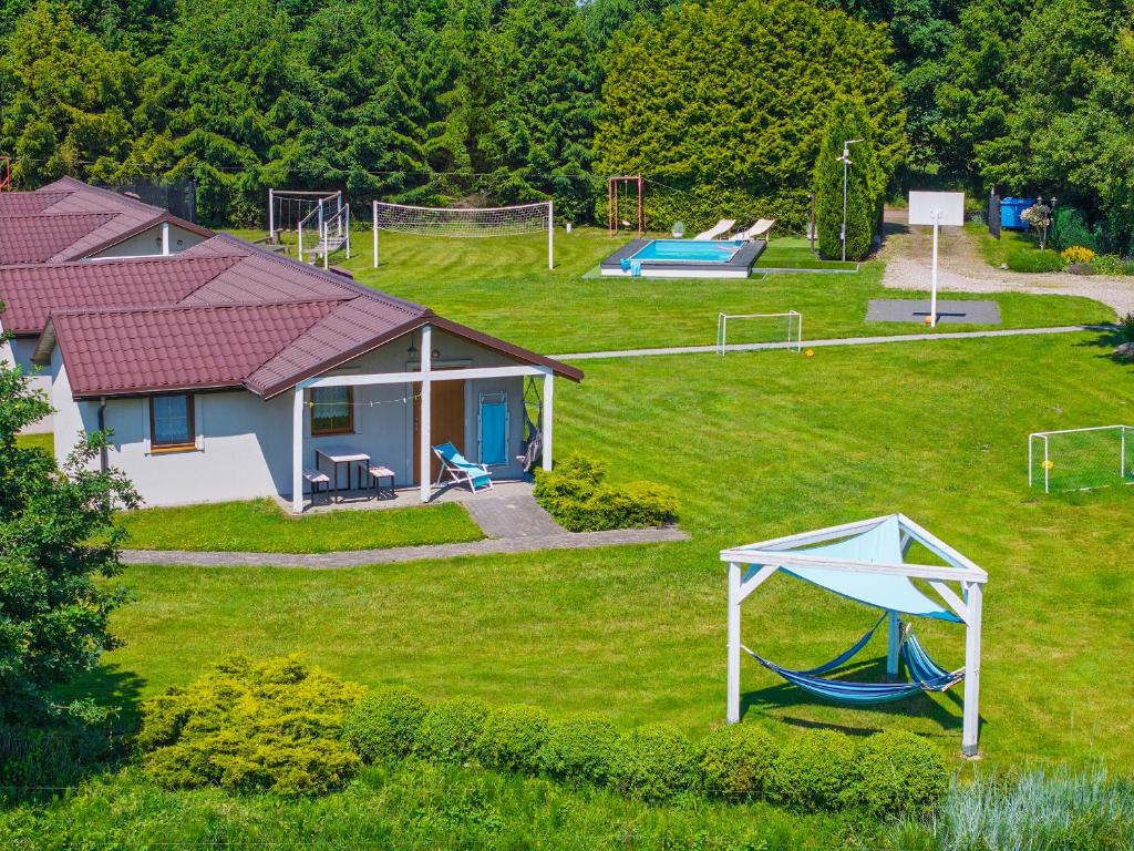 an aerial view of a yard with a house and a playground at Domki letniskowe Ranczo in Darłowo
