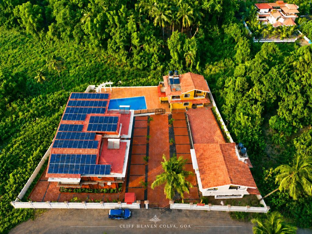 an aerial view of a house with solar panels on it at Cliff Heaven in Colva