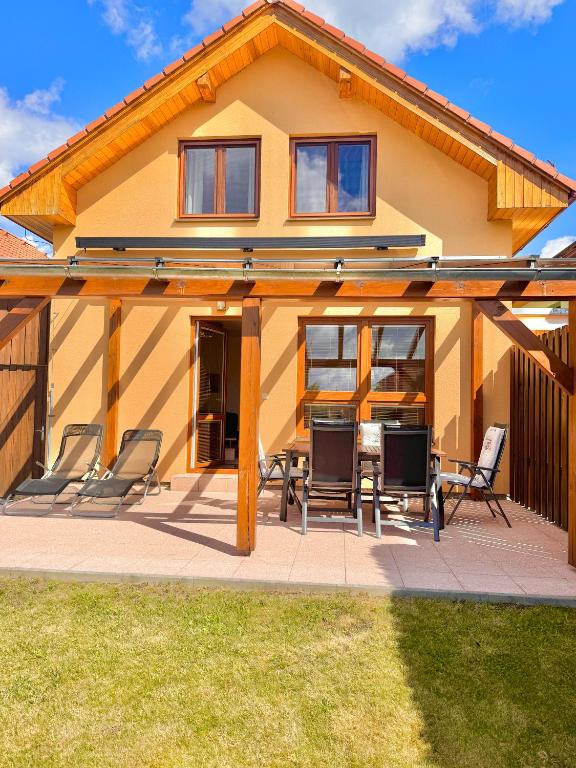 a house with chairs and a patio at Casa Maika in Frymburk