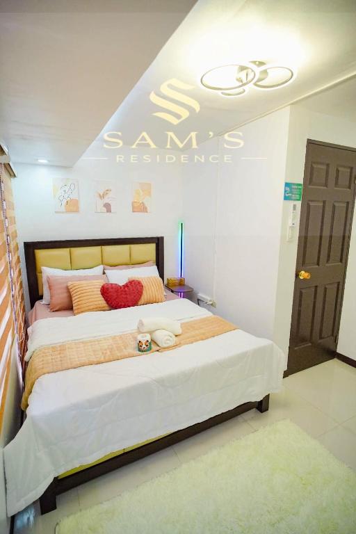 a bedroom with a bed with a sign on the wall at Sam's Residence in Marilao