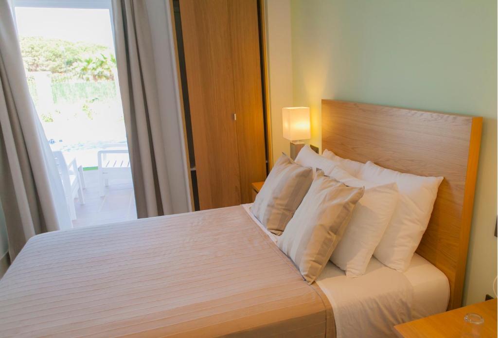 Postel nebo postele na pokoji v ubytování Hotel Novomar