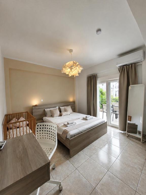 a large bedroom with a bed and a table at Anris & Dianas Dom - In a quiet part of the center in Kallithea Halkidikis