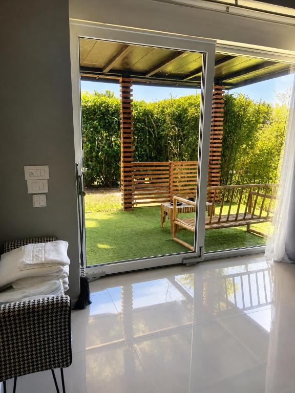 a room with a sliding glass door to a patio at Bambuus Garden & Spa in Drăgăşani