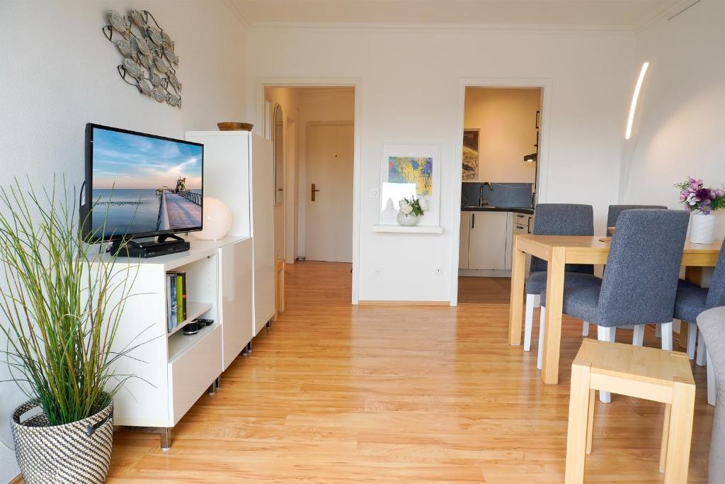 a living room with a television and a dining table at Ferienwohnung Seeland in Niendorf