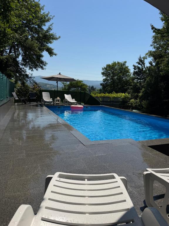 a swimming pool with a white bench next to it at Villa La Vida in Sarajevo