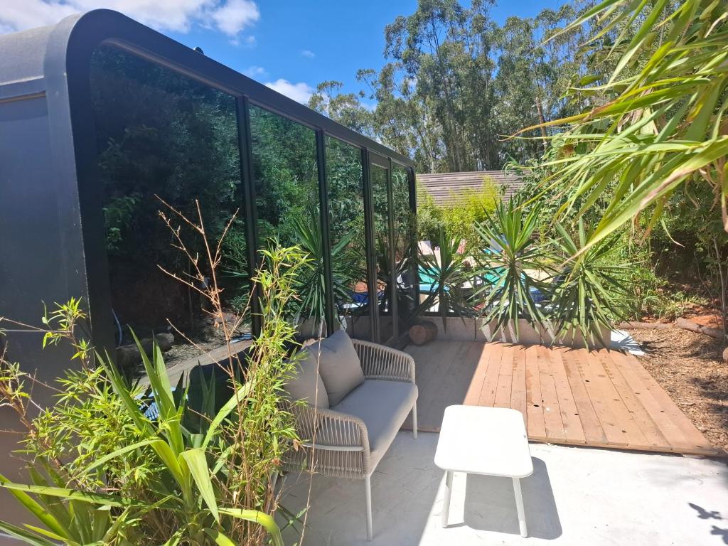 a patio with a chair and a table at FALCOARIA Eco in Setúbal