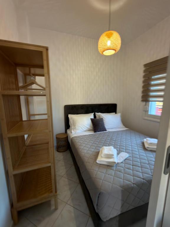 a bedroom with a bed with a towel on it at Munda suites in Amoudara Herakliou