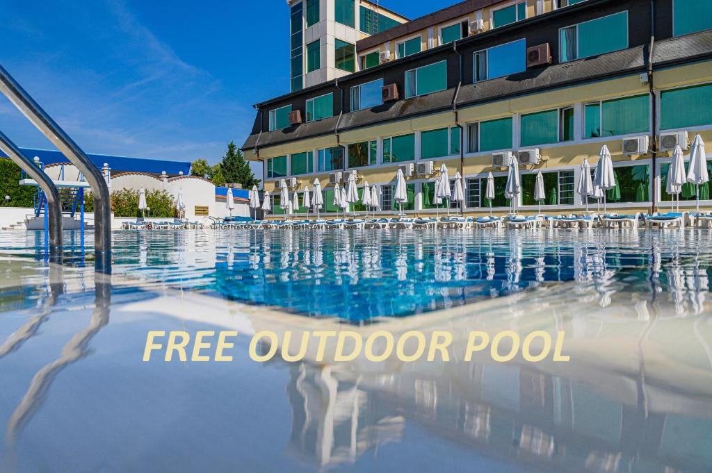 a swimming pool in front of a hotel at Hotel Montecito in Sofia
