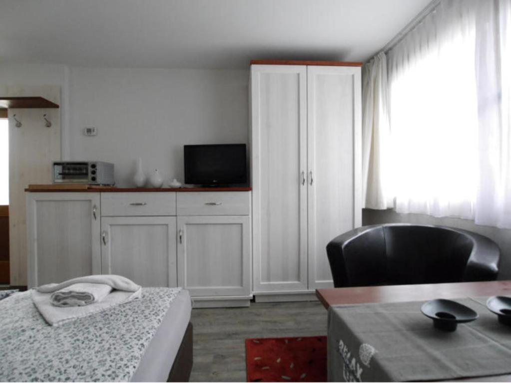 a room with a kitchen with a table and a chair at Bungalow in Bansin