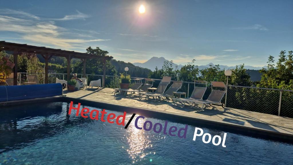 a pool with chairs and aemedcoded pool sign next to it at Villa Pavone in Coreglia Antelminelli