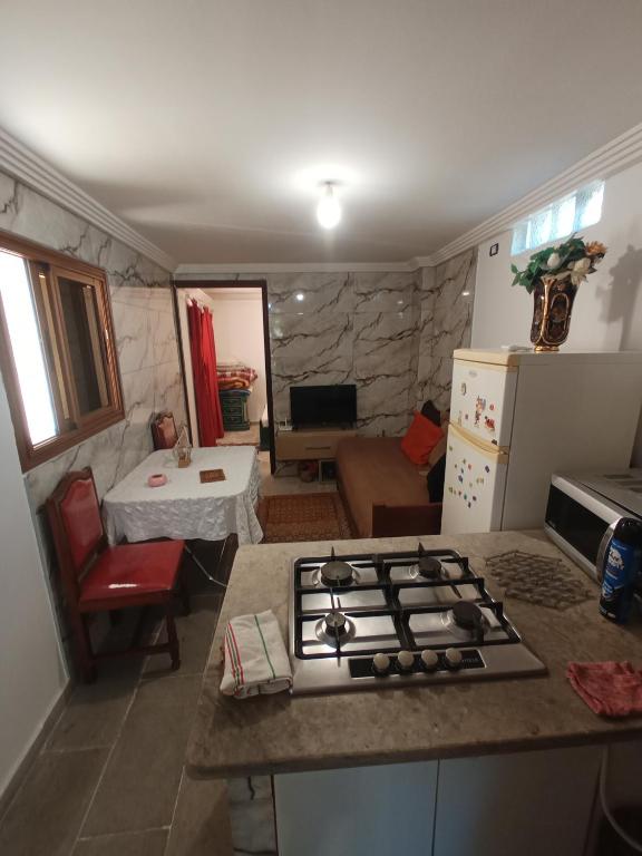 a kitchen with a stove top oven in a room at Maison Kram Plage in Le Kram
