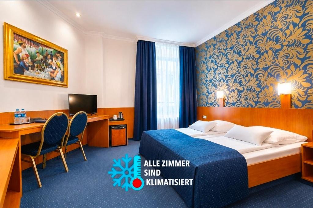 a hotel room with a bed and a desk and a computer at HOTEL ATLANTA Darmstadt SUPERIOR in Darmstadt