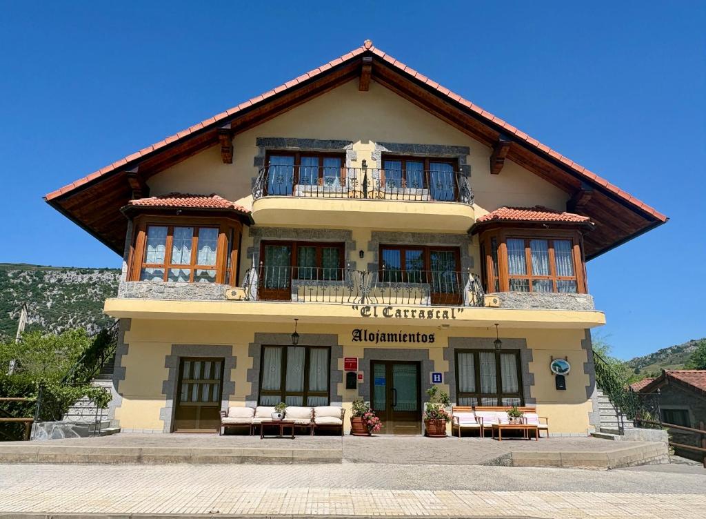 a large building with chairs in front of it at La Casona El Carrascal in La Gandara