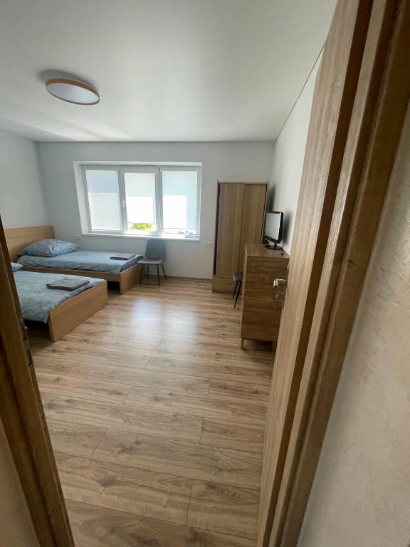 a large room with two beds and a window at Pušų Sodas in Birštonas