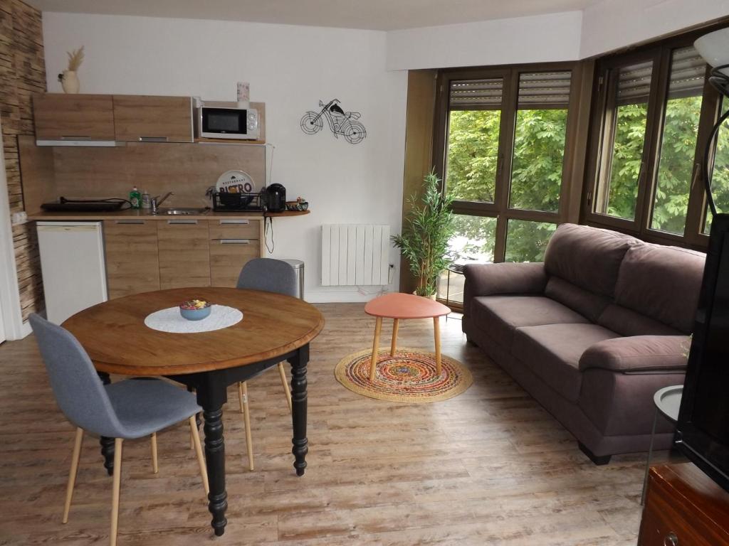 a living room with a table and a couch at briand in Charleville-Mézières