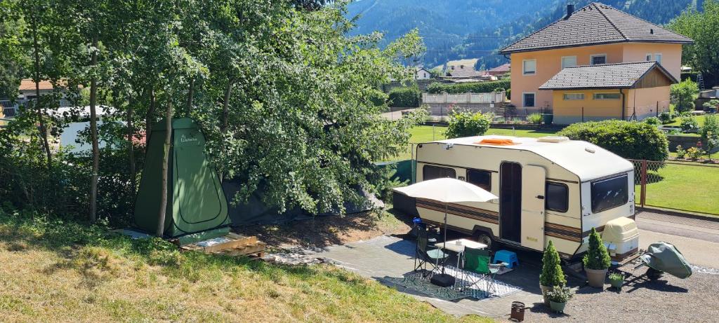 an rv parked in a driveway in front of a house at Tiny Anna's Cozy Home near Redbull Ring in Liesingthal