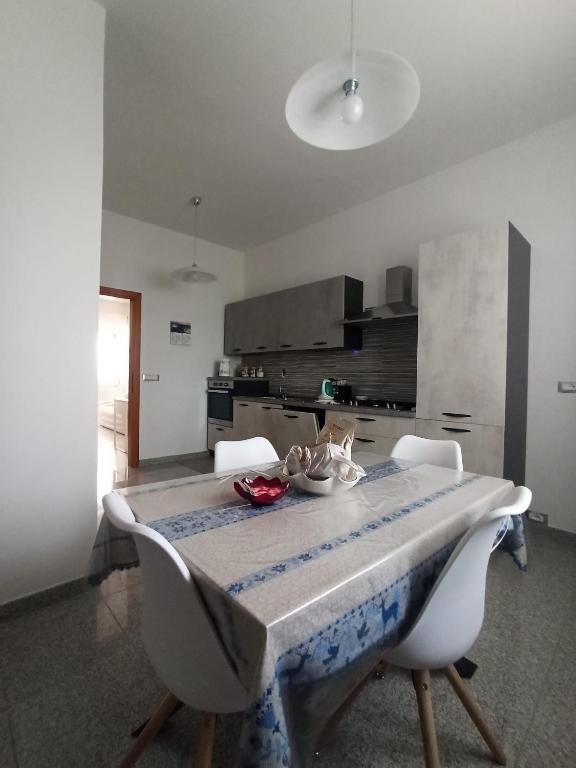 a dining room table with two chairs and a kitchen at Tra mare e vigneti in Ortona