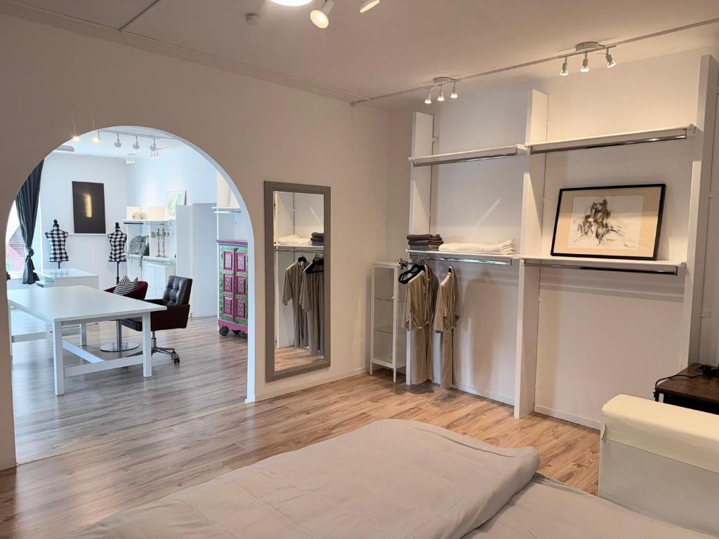 a living room with a table and a mirror at Wohnstudio Millstatt in Millstatt