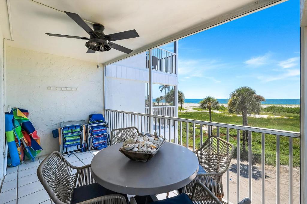 a table and chairs on a balcony with a view of the ocean at South Seas Beach Villa 2428 in Captiva