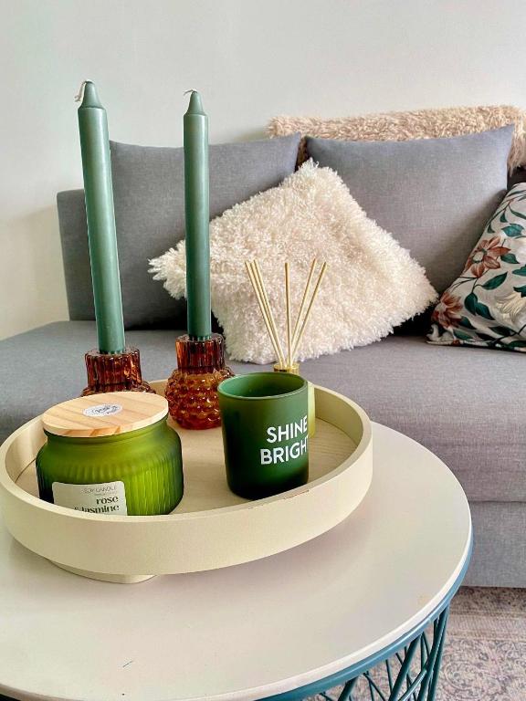 a table with three green candles on top of it at Väikekorter in Pärnu