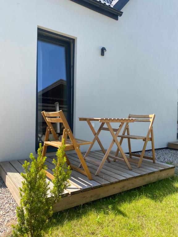 a wooden deck with a table and a chair at "Pas draugą" Šalkauskio g in Kaunas
