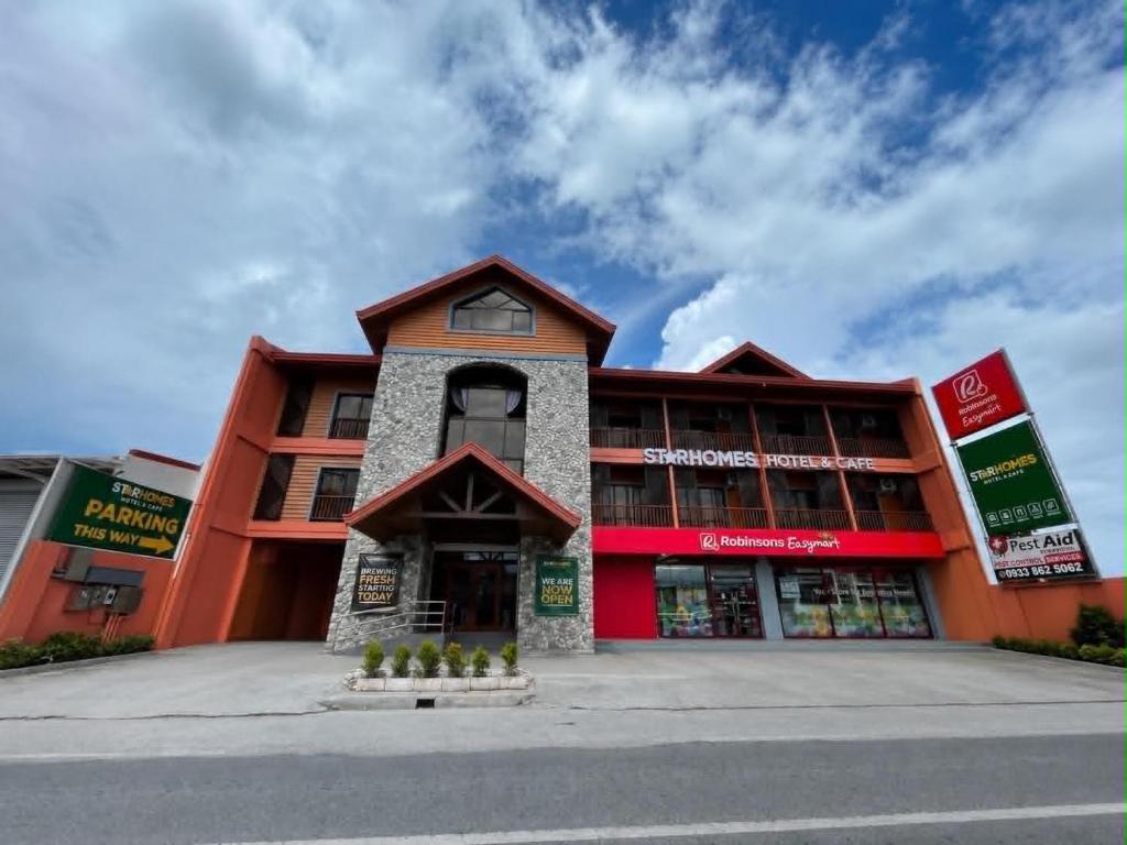a store front of a building on a street at Starhomes Hotel & Cafe in Tarlac