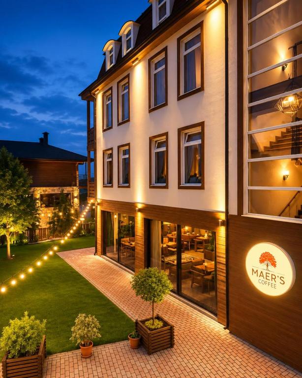 a large building with lights on the side of it at MAER'S Hotel in Qusar