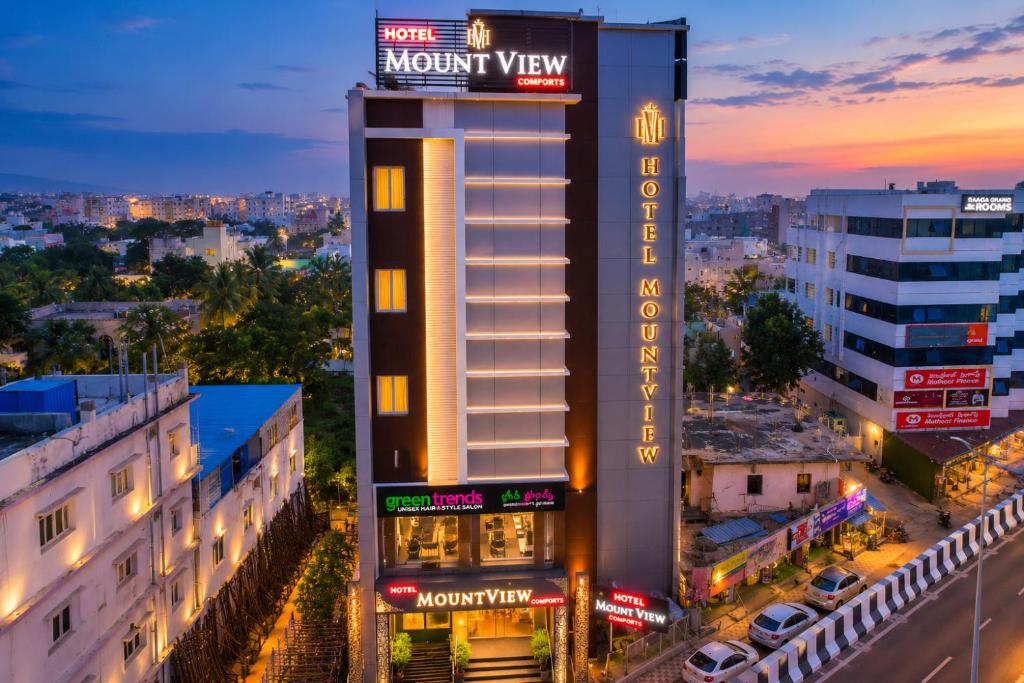 a view of a hotel with a night view at Hotel MountView Comforts in Tirupati