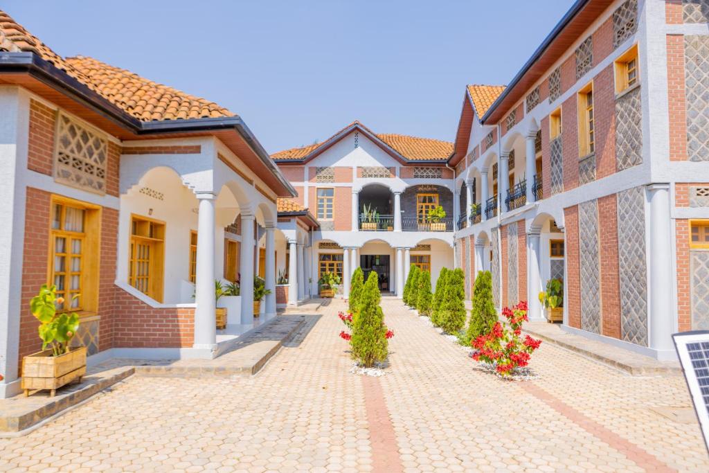a courtyard of a house with flowers and plants at MIRAMAR Ruhondo Resort in Muhororo