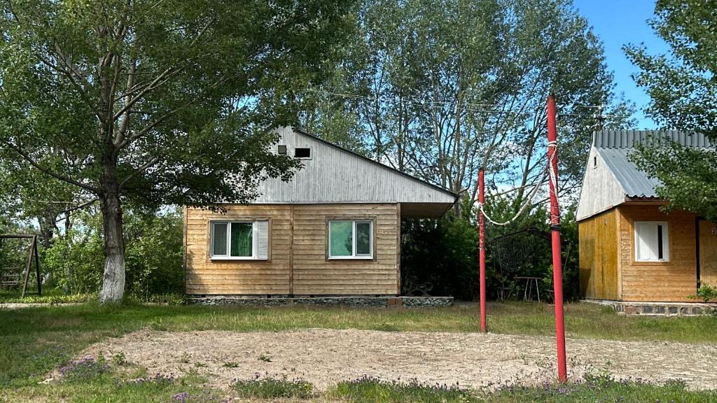 a small wooden house with a flag in front of it at Voyage in Sevan