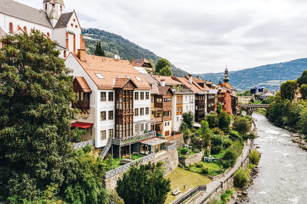 a view of a town with a river and buildings at VillaJazz Apartments in Murau