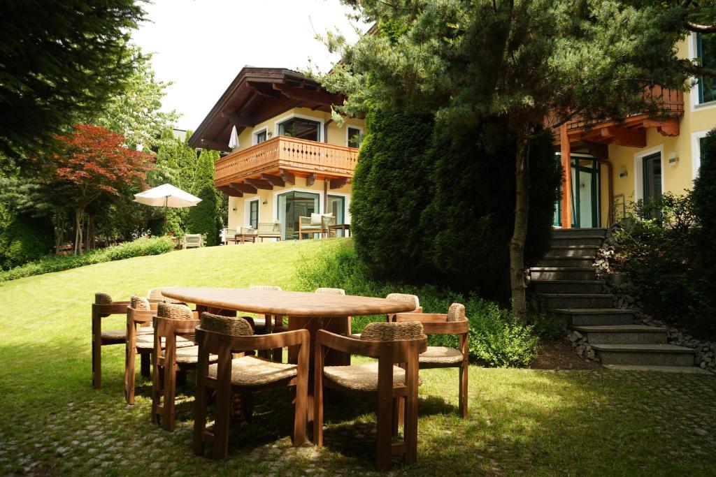a wooden table and chairs in front of a house at Haus Diana in Wagrain