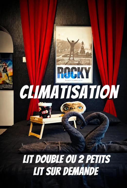 a poster for a movie with two snakes on a bed at Le cinoche in Woustviller