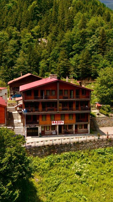 a large building in front of a mountain at Badul Pansiyon in Uzungöl