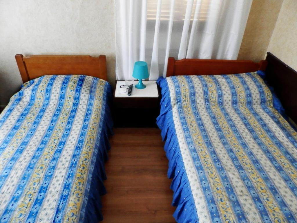 A bed or beds in a room at Akanthos Hotel