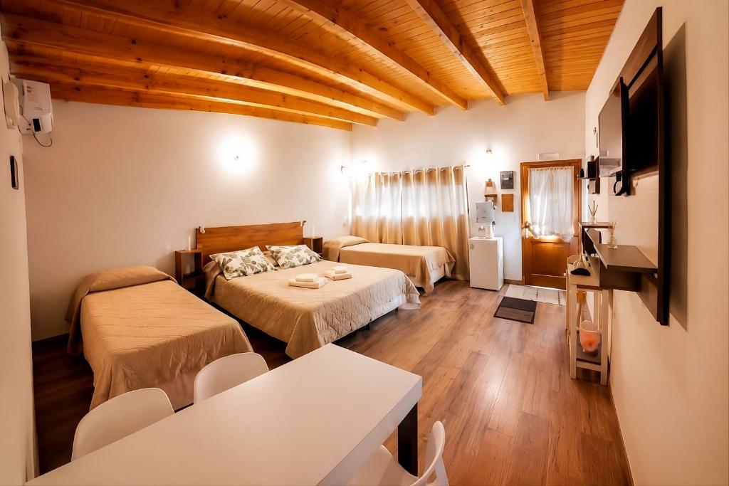 a hotel room with two beds and a couch at Raíces in Puerto Pirámides