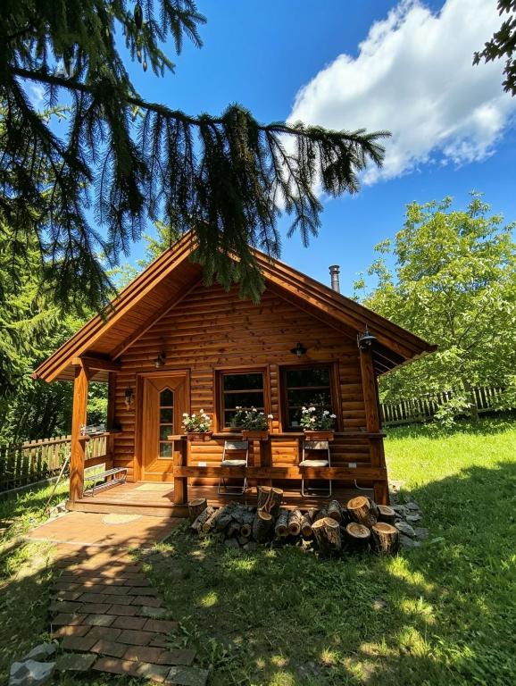 a log cabin with a porch and a deck at Belle-Aire Deux in Mátraszentimre