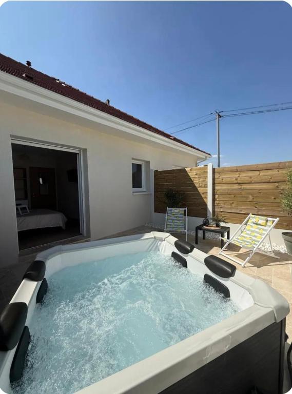 a hot tub in the backyard of a house at Maison de campagne avec SPA in Massay