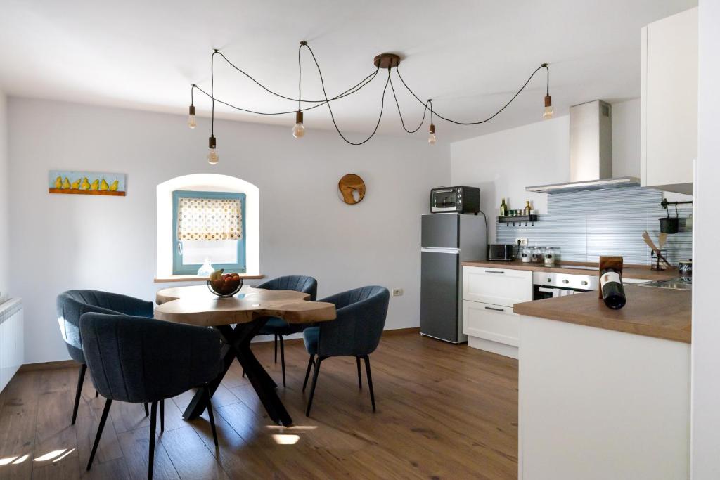 a kitchen and dining room with a table and chairs at Lukova hiša- Luka's house in Vipava