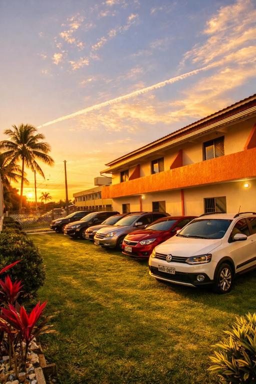 a row of cars parked in front of a building at Apartamentos PraiaMar in Ilha Comprida