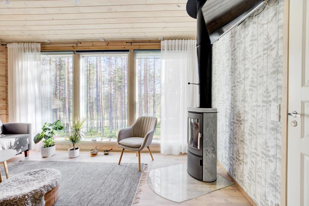 a living room with a fireplace in a house at Villa Winter - Valkea Homes in Pyhätunturi