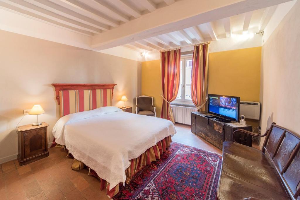 Postel nebo postele na pokoji v ubytování Palazzo Dalla Rosa Prati