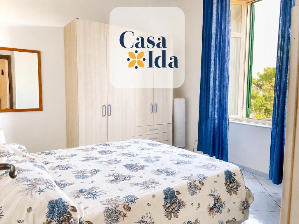 a room with a bed with aania sign on the wall at Amalfi Coast Casa Ida 1 in Vietri sul Mare