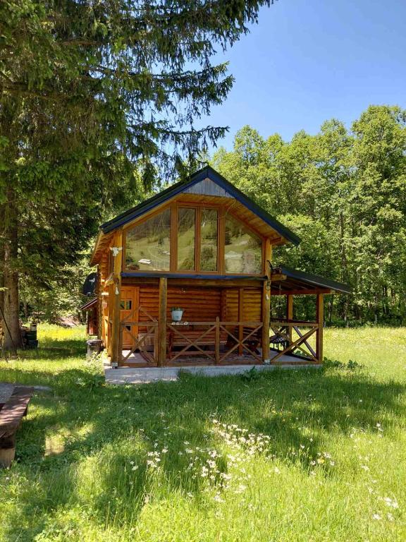 a large wooden cabin in a field of grass at Beco's Place in Plav